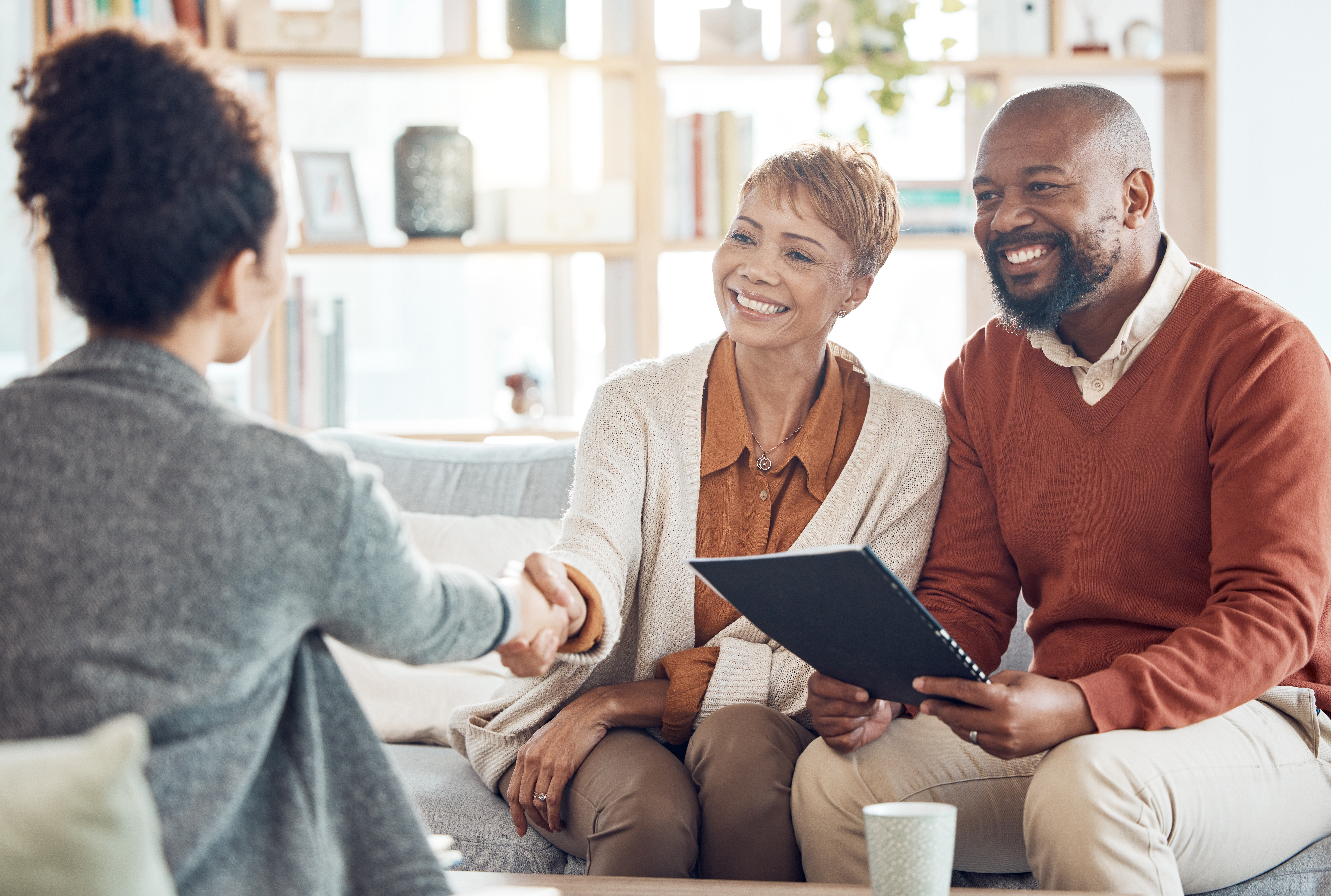 A man and a women meeting with their attorney to discuss their trusts and estates.