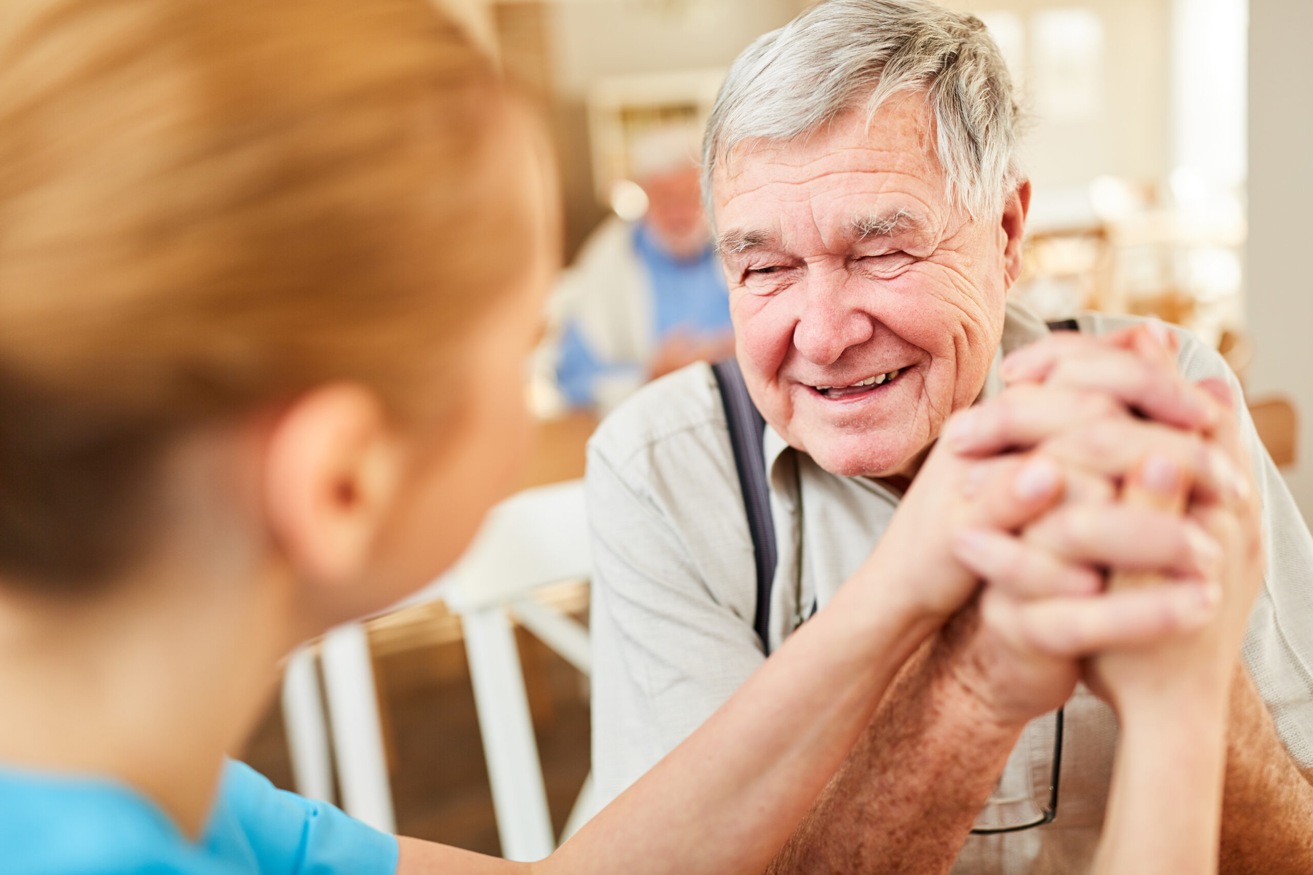 Elderly Father Holding Daughters Hand